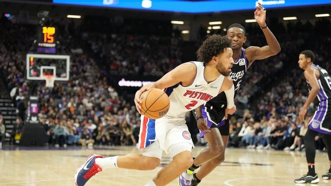 Detroit Pistons PG Cade Cunningham drives past San Antonio Spurs PG, and former Sacramento King, De'Aaron Fox. (Photo credit: Kelley L Cox-Imagn Images)