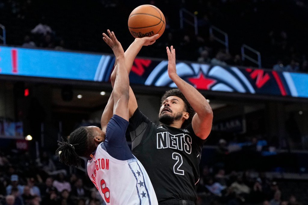 Nets forward Cameron Johnson (2) goes up to shoot against Washington Wizards guard Bub Carrington (8) during the second half of an NBA basketball game, Monday, Feb. 24, 2025.