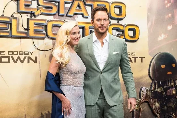 A man and woman posing before a film premiere