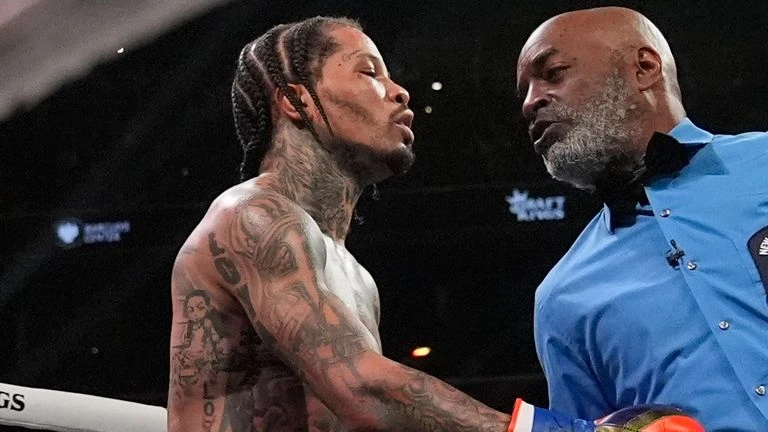 Gervonta Davis talks to the referee during the fourth round of his WBA lightweight championship boxing bout against Lamont Roach (AP Photo/Frank Franklin II)