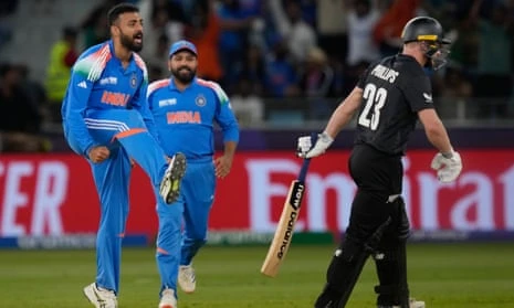 India's Varun Chakravarthy (left) celebrates the wicket of New Zealand's Glenn Phillips.