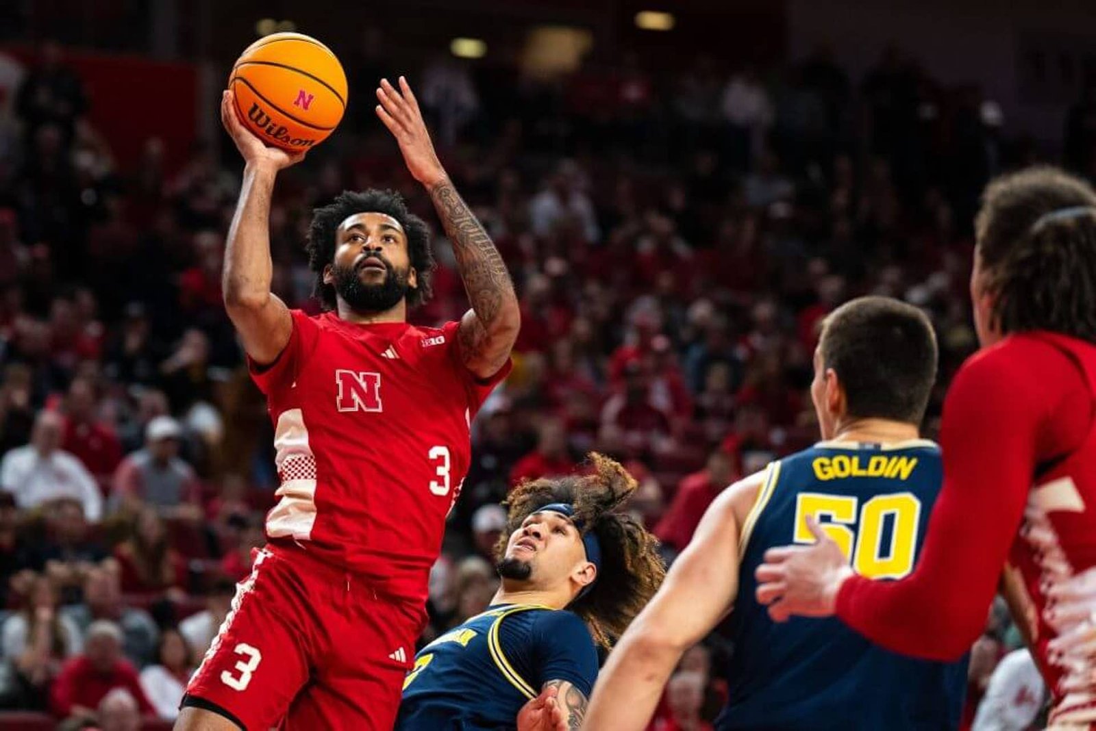 Feb 24, 2025; Lincoln, Nebraska, USA; Nebraska Cornhuskers guard Brice Williams (3) shoots the ball against Michigan Wolverines guard Tre Donaldson (3) and center Vladislav Goldin (50) during the first half at Pinnacle Bank Arena.