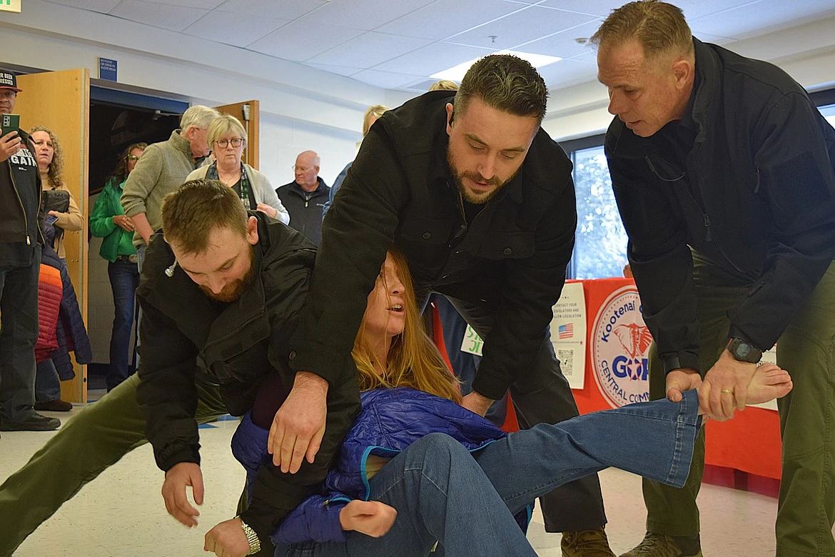 Three employees of private security firm LEAR Asset Management dragged Post Falls resident Teresa Borrenpohl out of a town hall meeting in Coeur d'Alene