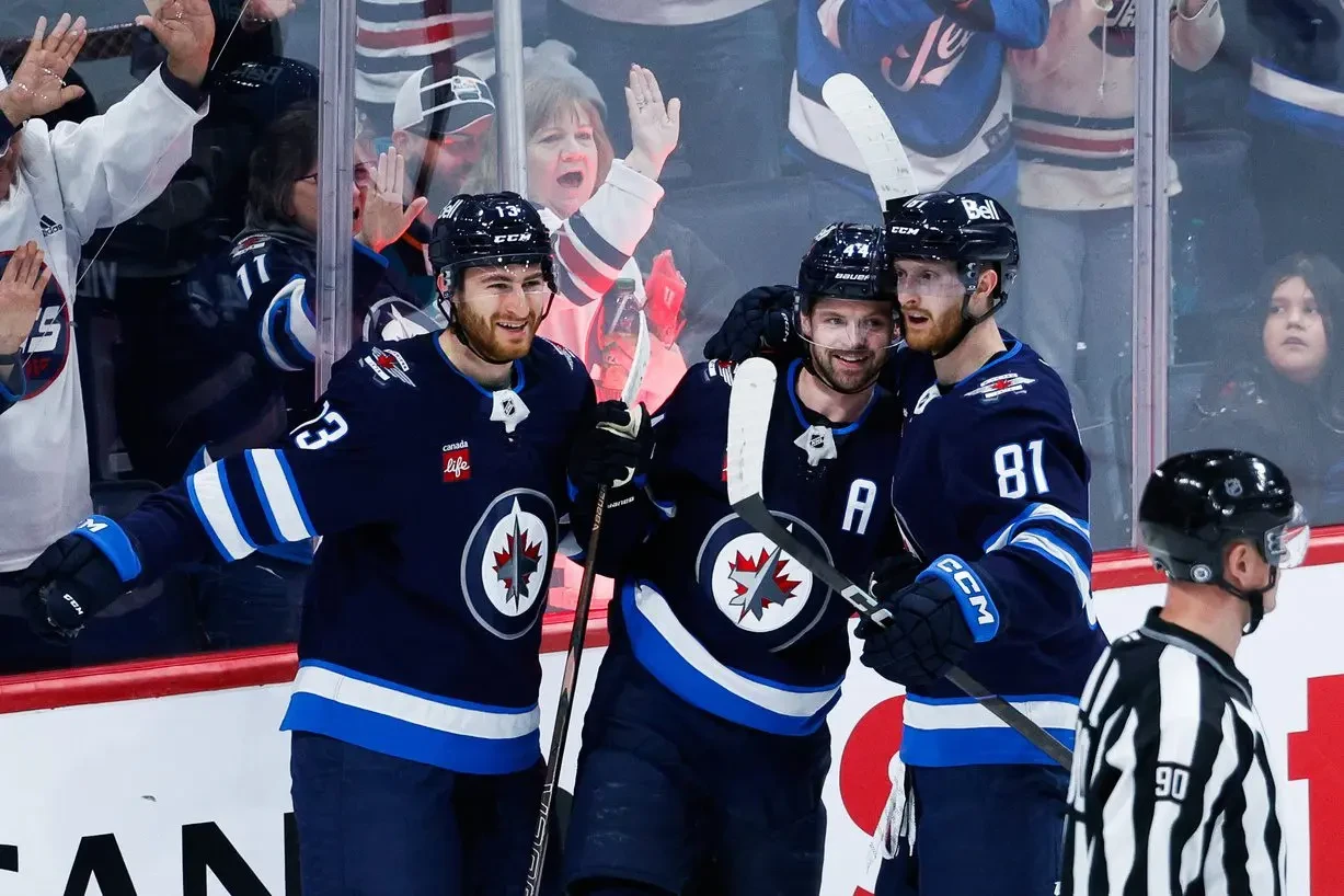 Winnipeg Jets defenseman Josh Morrissey (44) is congratulated by his team mates on his goal against the San Jose Sharks during the third period at Canada Life Centre