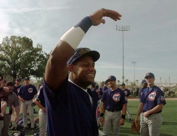 Cubs outfielder Sammy Sosa greets his teammates on the field at Fitch Park after making his debut at spring training March 1, 1999, in Mesa, Ariz.