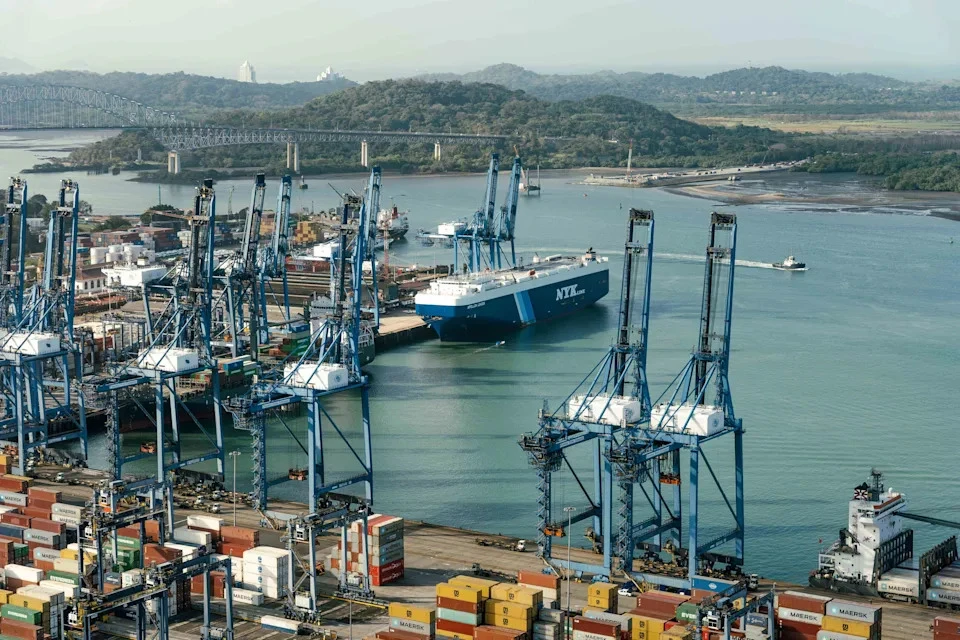 Containers and cranes at the Port of Balboa at the Pacific entrance of the Panama Canal in Panama City, Panama, photographed by Walter Hurtado / Bloomberg via Getty Images, symbolize the bustling activity that drives global trade. As the Panama Canal ports change hands, this image represents the gateway to new opportunities for investors and economies alike.