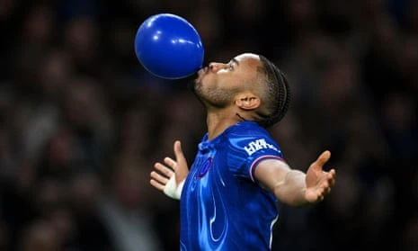 Christopher Nkunku celebrates after opening the scoring  by blowing up a blue balloon