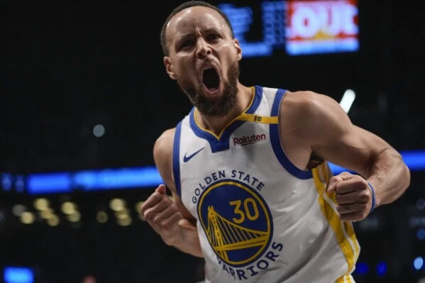 Golden State Warriors' Stephen Curry (30) celebrates after making a three-point shot during the second half of an NBA basketball game against the Brooklyn Nets Thursday, March 6, 2025, in New York. (AP Photo/Frank Franklin II)