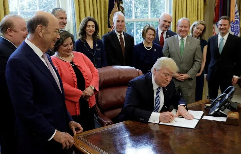 FILE PHOTO: U.S. President Trump signs a Memorandum on Aluminum Imports and Threats to National Security at the White House in Washington, sparking concerns over aluminium premiums and metal imports, Reuters.