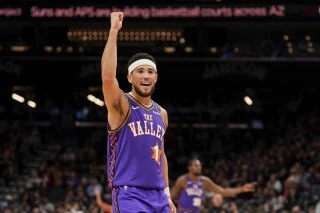 Phoenix Suns guard Devin Booker (1) celebrates a play during the second half of an NBA basketball game against the Portland Trail Blazers, Sunday, Dec. 15, 2024, in Phoenix. (AP Photo/Samantha Chow)