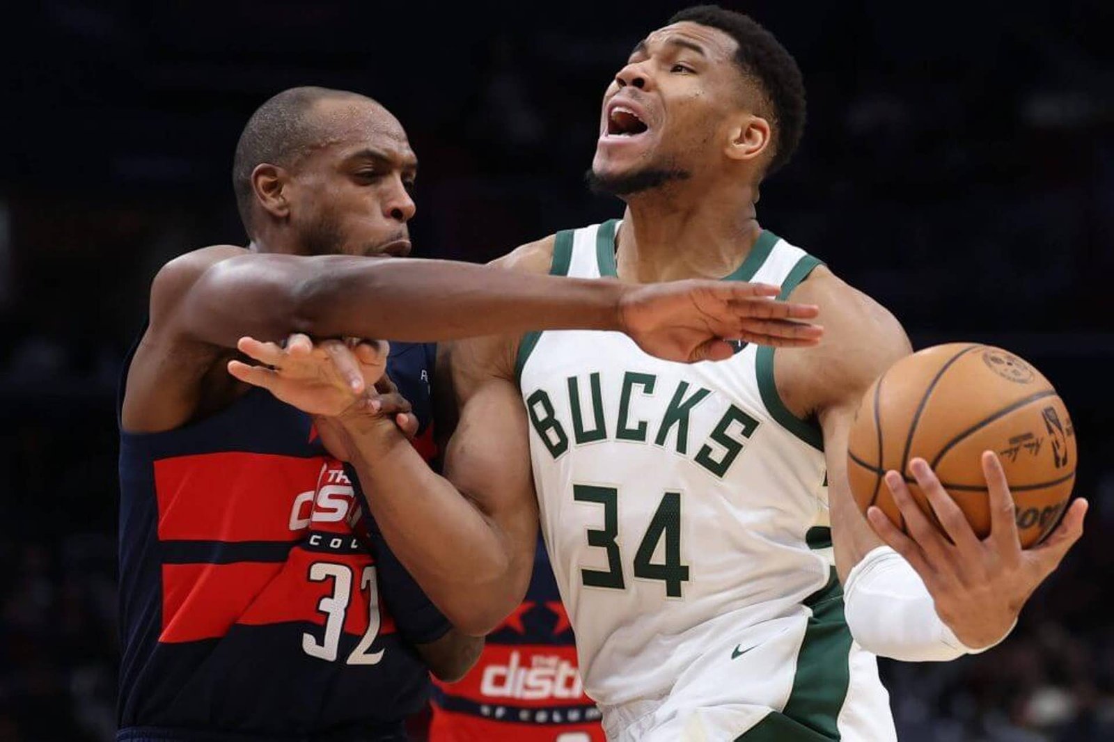 WASHINGTON, DC - FEBRUARY 21: Giannis Antetokounmpo #34 of the Milwaukee Bucks dribbles past Khris Middleton #32 of the Washington Wizards during the second half at Capital One Arena on February 21, 2025 in Washington, DC.