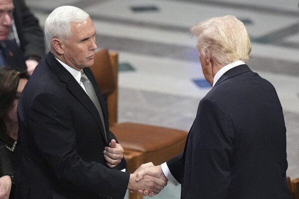 President-elect Donald Trump, right, shakes hands with former Vice President Mike Pence before the state funeral for former President Jimmy Carter at Washington National Cathedral in Washington, Jan. 9, 2025. (AP Photo/Jacquelyn Martin, File)