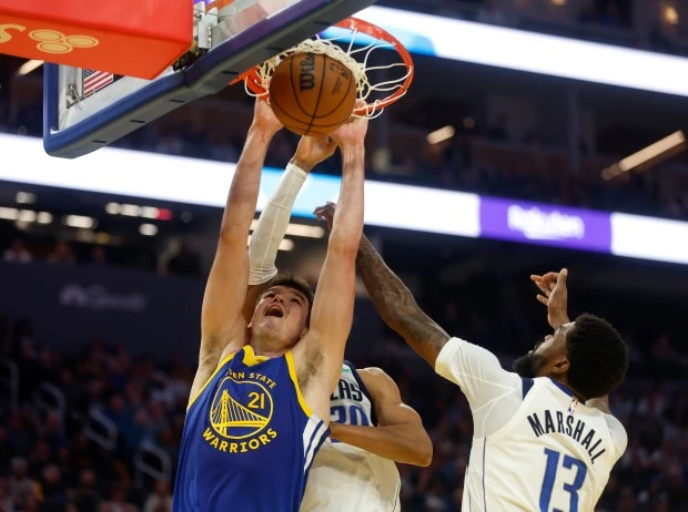 Golden State Warriors' Quinten Post (21) dunks against Dallas Mavericks' Kessler Edwards (20) and Dallas Mavericks' Naji Marshall (13) in the second quarter at the Chase Center in San Francisco, Calif., on Sunday, Feb. 23, 2025.