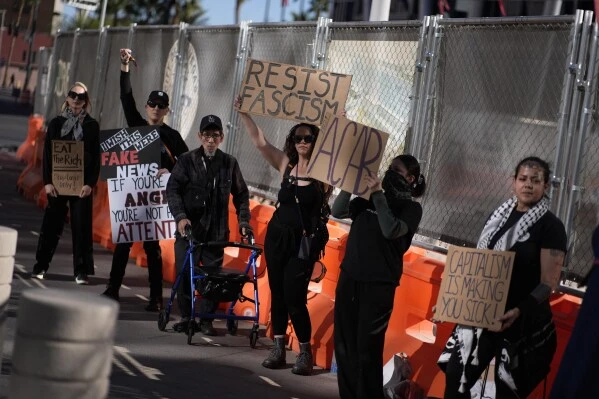 Protestors hold signs during a rally for a nationwide economic blackout Wednesday, Feb. 26, 2025, in Las Vegas. (AP Photo/John Locher)