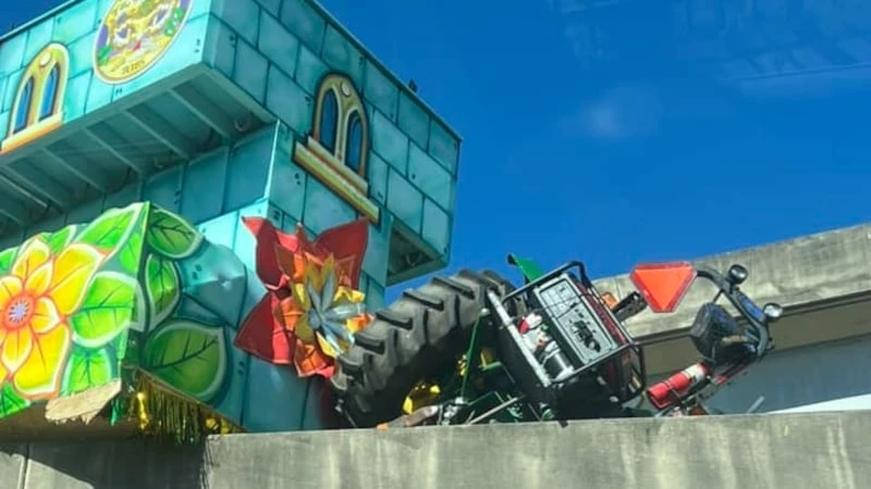 A tractor pulling a Mardi Gras float tipped over, closing lanes of the highway at the...