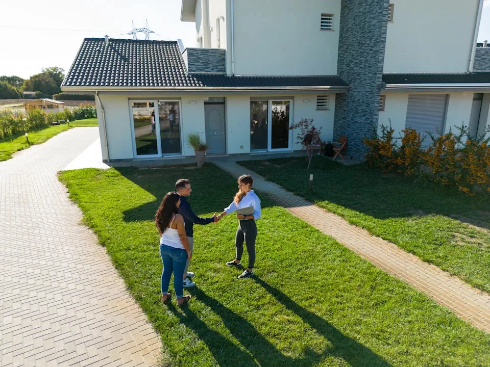 "Yahoo Personal Finance · LeoPatrizi via Getty Images: A family standing in front of their newly purchased home, symbolizing the joy and relief of finding the perfect financing solution."