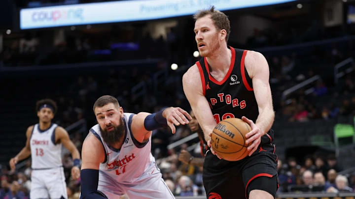 Jan 29, 2025; Washington, District of Columbia, USA; Toronto Raptors center Jakob Poeltl (19) holds the ball as Washington Wizards center Jonas Valanciunas (17) reaches in the second quarter at Capital One Arena. Mandatory Credit: Geoff Burke-Imagn Images