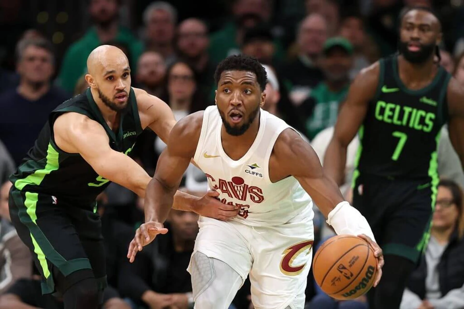 BOSTON, MASSACHUSETTS - FEBRUARY 28: Donovan Mitchell #45 of the Cleveland Cavaliers dribbles past Derrick White #9 of the Boston Celtics during the second half at TD Garden on February 28, 2025 in Boston, Massachusetts. The Cavaliers defeat the Celtics 123-116.