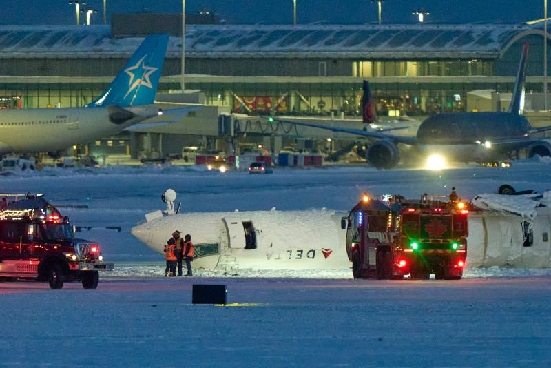 A Delta Air Lines plane lies upside down after crashing upon landing at Toronto Pearson International Airport in Mississauga, Ontario, Monday.