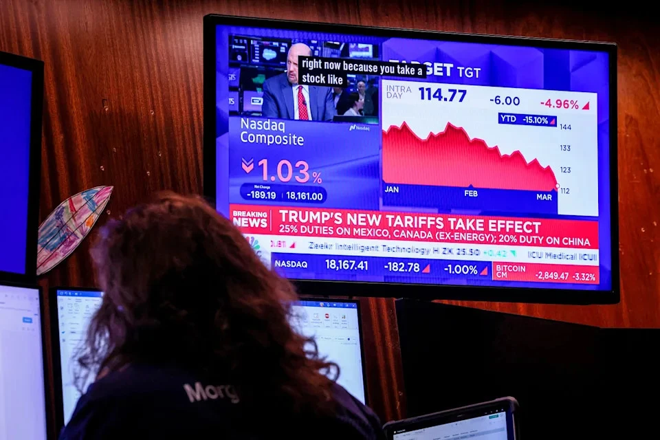 A television on the floor of the New York Stock Exchange displays financial news during morning trading on Tuesday, as investors closely watch the market's reaction to the newly imposed tariffs. (Photo credit: NBCNews.com)