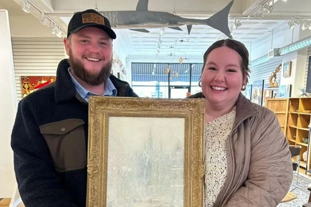 An image collage containing 1 images, Image 1 shows Couple holding a framed painting