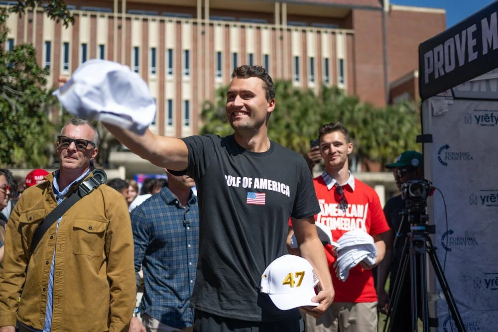 Charlie Kirk throws hats before an event at the Plaza of the America’s in Gainesville, Fla., on Thursday, Feb. 27, 2025.