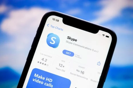 a smartphone screen shows the Skype app