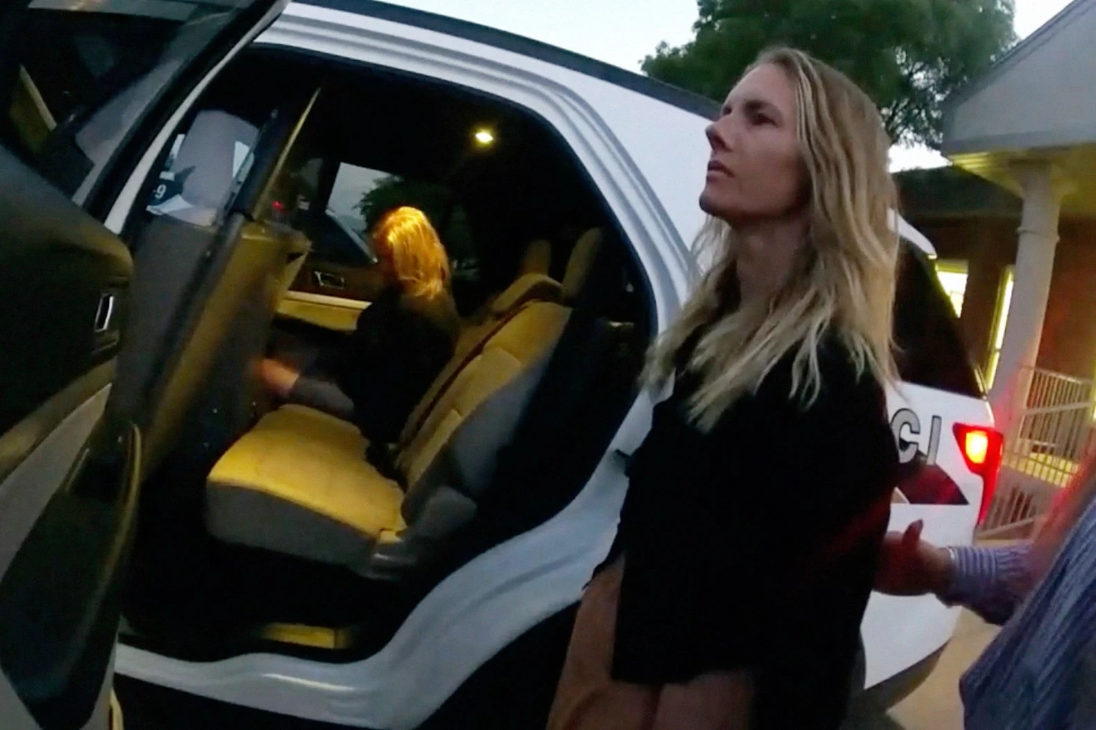 This image taken from body camera footage provided by Washington County Attorney's Office shows Jodi Hildebrandt, left, and Ruby Franke, center, being arrested on child abuse charges on Aug. 30, 2023, in Ivins, Utah.