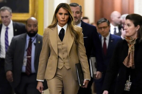 First lady Melania Trump, from center to right, followed by Sen. Ted Cruz, R-Texas, and House Speaker Mike Johnson, R-La., walks through the Capitol, Monday, March 3, 2025, in Washington. (AP Photo/Julia Demaree Nikhinson)