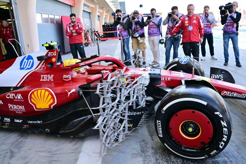 Photographers take pictures of Lewis Hamilton in the Ferrari