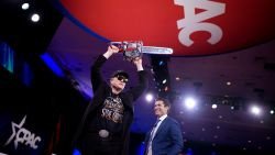 OXON HILL, MARYLAND - FEBRUARY 20: CEO of Tesla and SpaceX Elon Musk wields a chainsaw as he leaves the stage alongside Newsmax anchor Rob Schmitt at the Conservative Political Action Conference (CPAC) at the Gaylord National Resort Hotel And Convention Center on February 20, 2025 in Oxon Hill, Maryland.