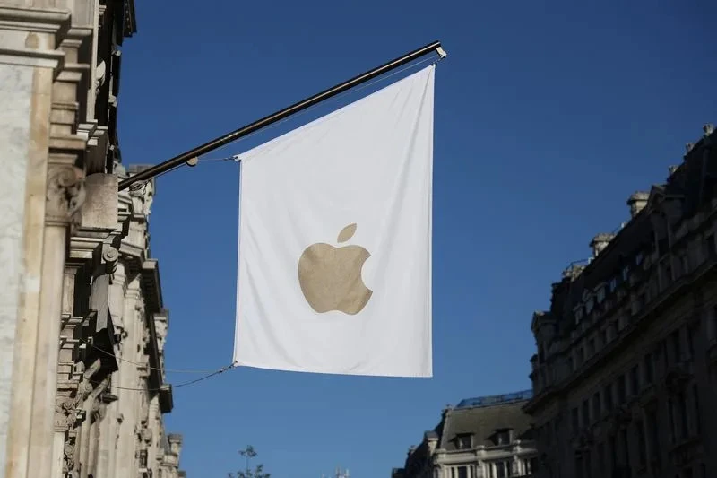 A view of a signage outside an Apple store in London, symbolizing the tech giant's commitment to user privacy, as reported by Reuters. The image represents the physical presence of Apple in the UK, where the company has been locked in a battle with the government over encryption and surveillance.