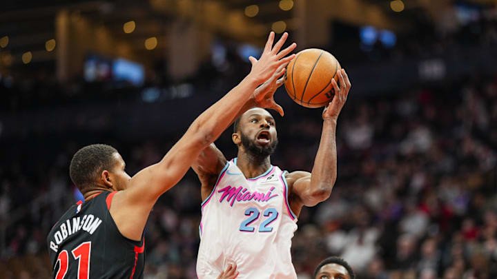 Feb 21, 2025; Toronto, Ontario, CAN; Miami Heat forward Andrew Wiggins (22) drives to the basket against Toronto Raptors center Orlando Robinson (21) during the first half at Scotiabank Arena.