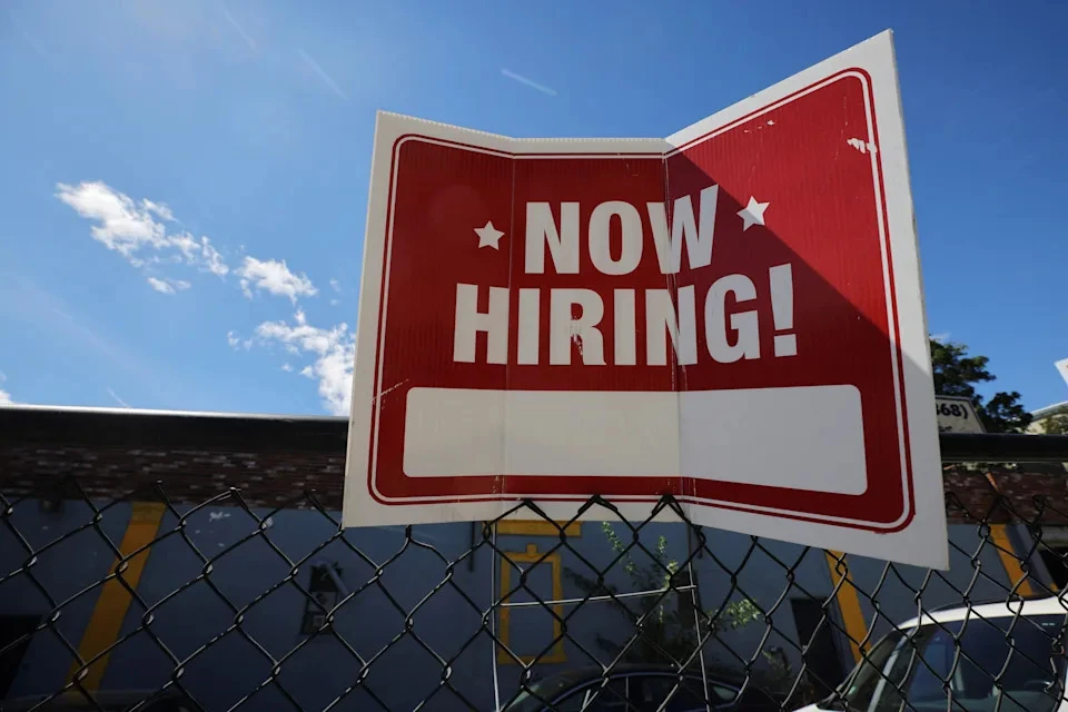 A "now hiring" sign is displayed outside Taylor Party and Equipment Rentals in Somerville, Mass., on Sept. 1, 2022, as economic uncertainty and consumer spending slowdown impact the labor market, Reuters/Brian Snyder/File Photo.