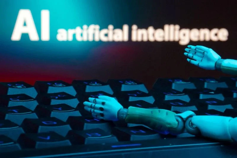 "FILE PHOTO: Illustration shows message reading 'AI artificial intelligence', keyboard and robot hands, symbolizing Digg's AI-driven revival, courtesy of Reuters"