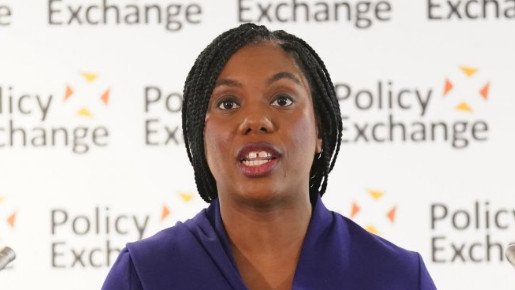 Conservative Party leader Kemi Badenoch delivers a speech at Policy Exchange in Westminster. She wears an indigo dress.