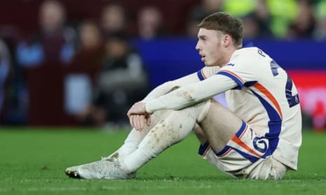 Cole Palmer sits on the pitch during Chelsea's defeat by Aston Villa.