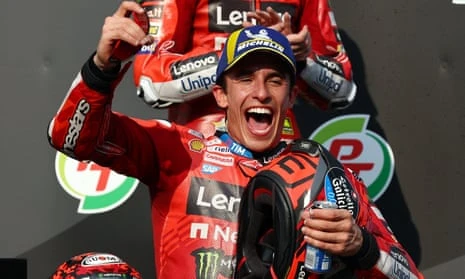 Marc Márquez celebrates on the podium at the Buriram International Circuit.