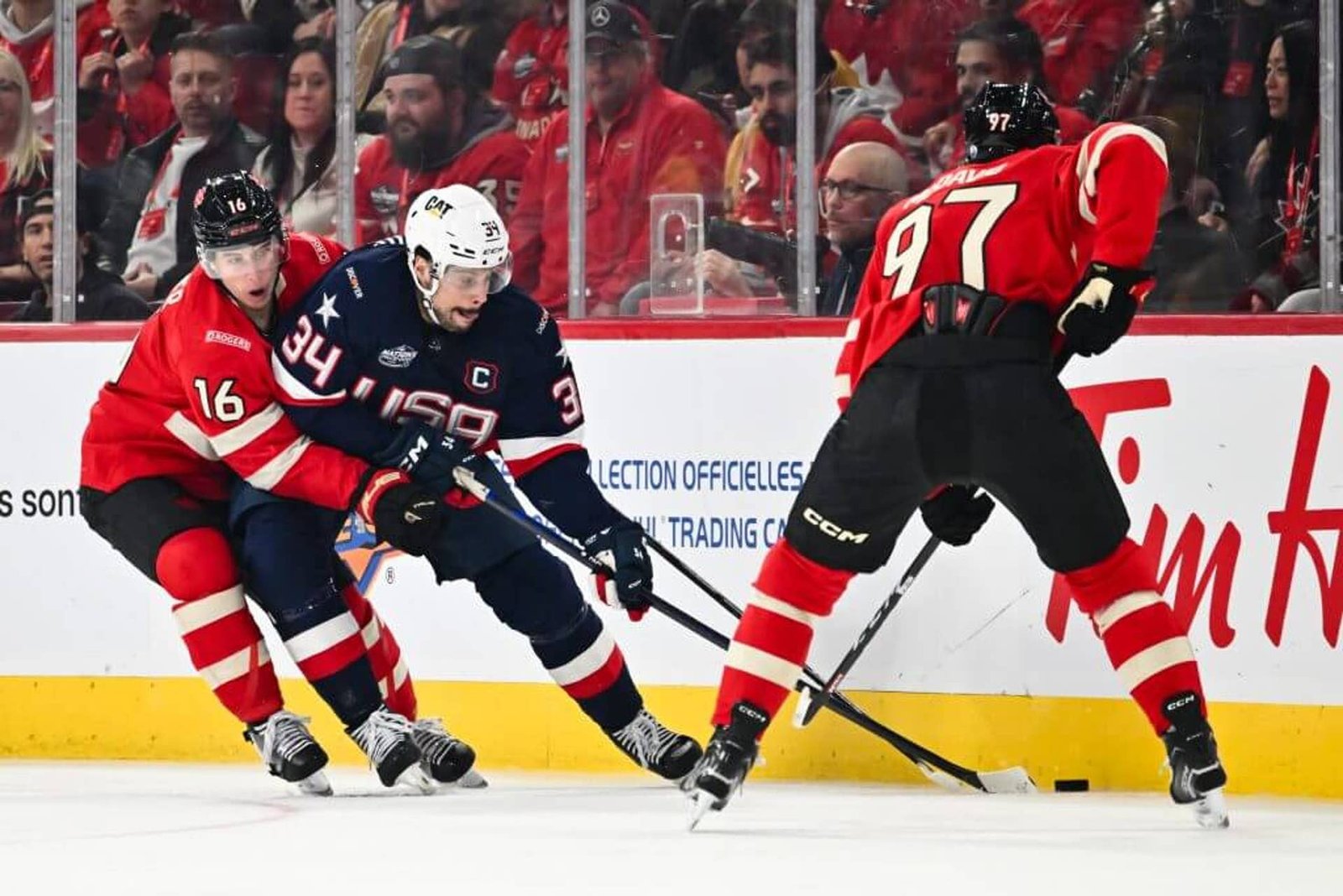 MONTREAL, CANADA - FEBRUARY 15:  Mitch Marner #16 of Team Canada challenges Auston Matthews #34 of Team USA during the second period in the 2025 NHL 4 Nations Face-Off at the Bell Centre on February 15, 2025 in Montreal, Quebec, Canada. Team USA defeated Team Canada 3-1.  (Photo by Minas Panagiotakis/Getty Images)