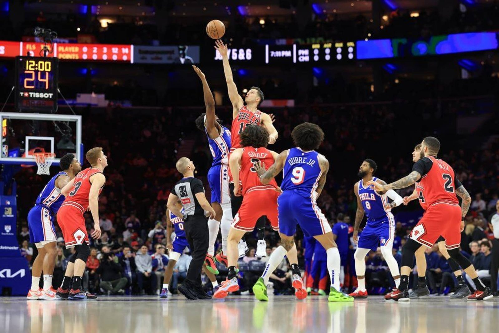 Feb 24, 2025; Philadelphia, Pennsylvania, USA; Chicago Bulls forward Zach Collins (12) and Philadelphia 76ers forward Guerschon Yabusele (28) tip off to start the game at Wells Fargo Center.