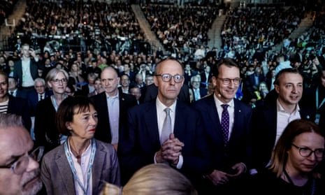 CDU leader Friedrich Merz, centre, clasping his hands, at an election rally in a stadium full of people in Oberhausen, Germany, on Friday.