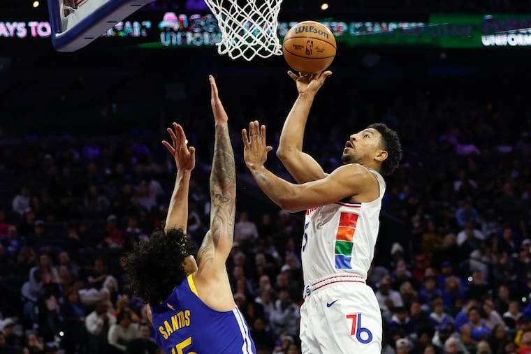 Sixers guard Quentin Grimes lays-up the basketball against Golden State Warriors forward Gui Santos during the third quarter on Saturday, March 1, 2025 in Philadelphia.