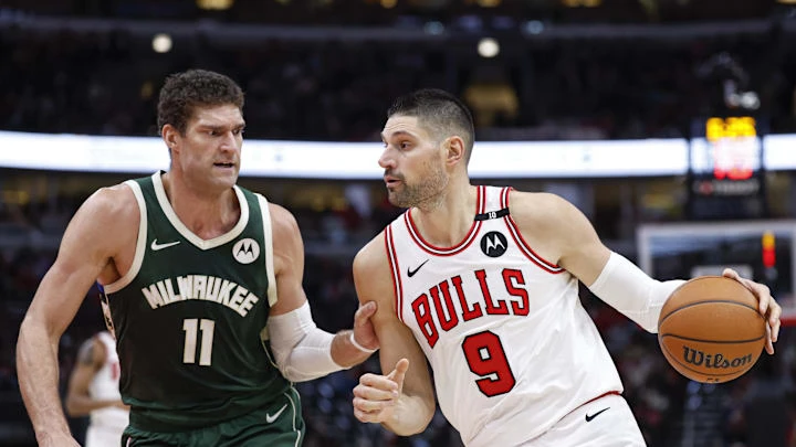 Dec 23, 2024; Chicago, Illinois, USA; Chicago Bulls center Nikola Vucevic (9) drives to the basket against Milwaukee Bucks center Brook Lopez (11) during the first half at United Center. Mandatory Credit: Kamil Krzaczynski-Imagn Images