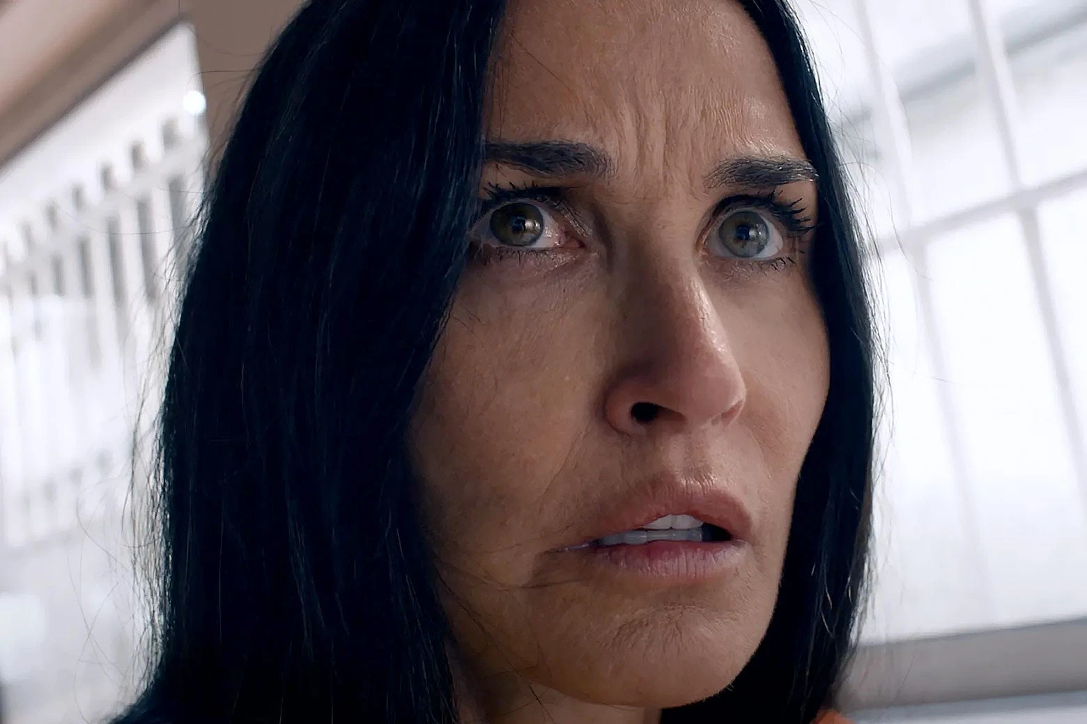 Demi Moore in The Substance, looking tired, haggard, and intense.