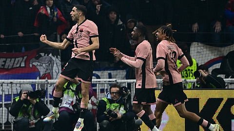 Paris Saint-German defender Achraf Hakimi (L) celebrates after scoring PSG's first goal during the French L1 football match between Olympique Lyonnais (OL) and PSG at the Parc Olympique Lyonnais in Decines-Charpieu, central-eastern France, on February 23, 2025.