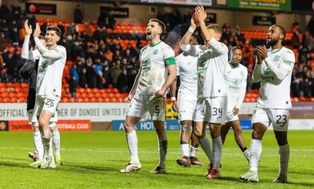 Hibs players salute their big following at Tannadice