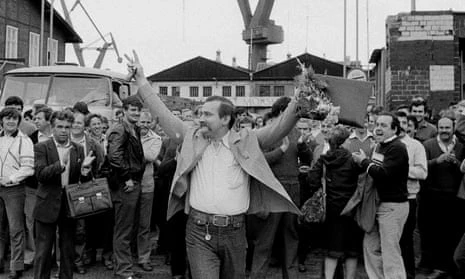 Lech Walesa raises his arms to a cheering crowd