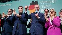 Friedrich Merz (R), leader of Germany's conservative Christian Democratic Union (CDU) and his party's main candidate for chancellor, reacts as he addresses supporters next to Bavaria's State Premier and Leader of the conservative Christian Social Union (CSU) Markus Soeder (2L), CDU Secretary General Carsten Linnemann (L) and CDU Vice-Secretary General Christina Stumpp (R) after the first exit polls in the German general elections were announced on TV during the electoral evening in Berlin on February 23, 2025.