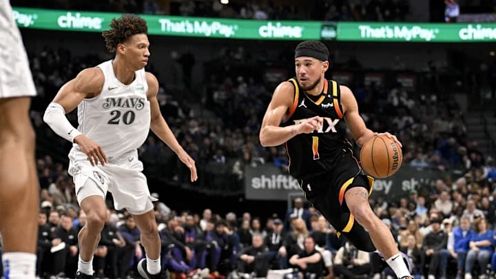 Mar 9, 2025; Dallas, Texas, USA; Phoenix Suns guard Devin Booker (1) drives to the basket past Dallas Mavericks forward Kessler Edwards (20) during the second quarter at the American Airlines Center. Mandatory Credit: Jerome Miron-Imagn Images