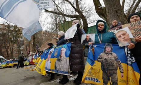 Ukrainians hold placards during a rally in Kyiv